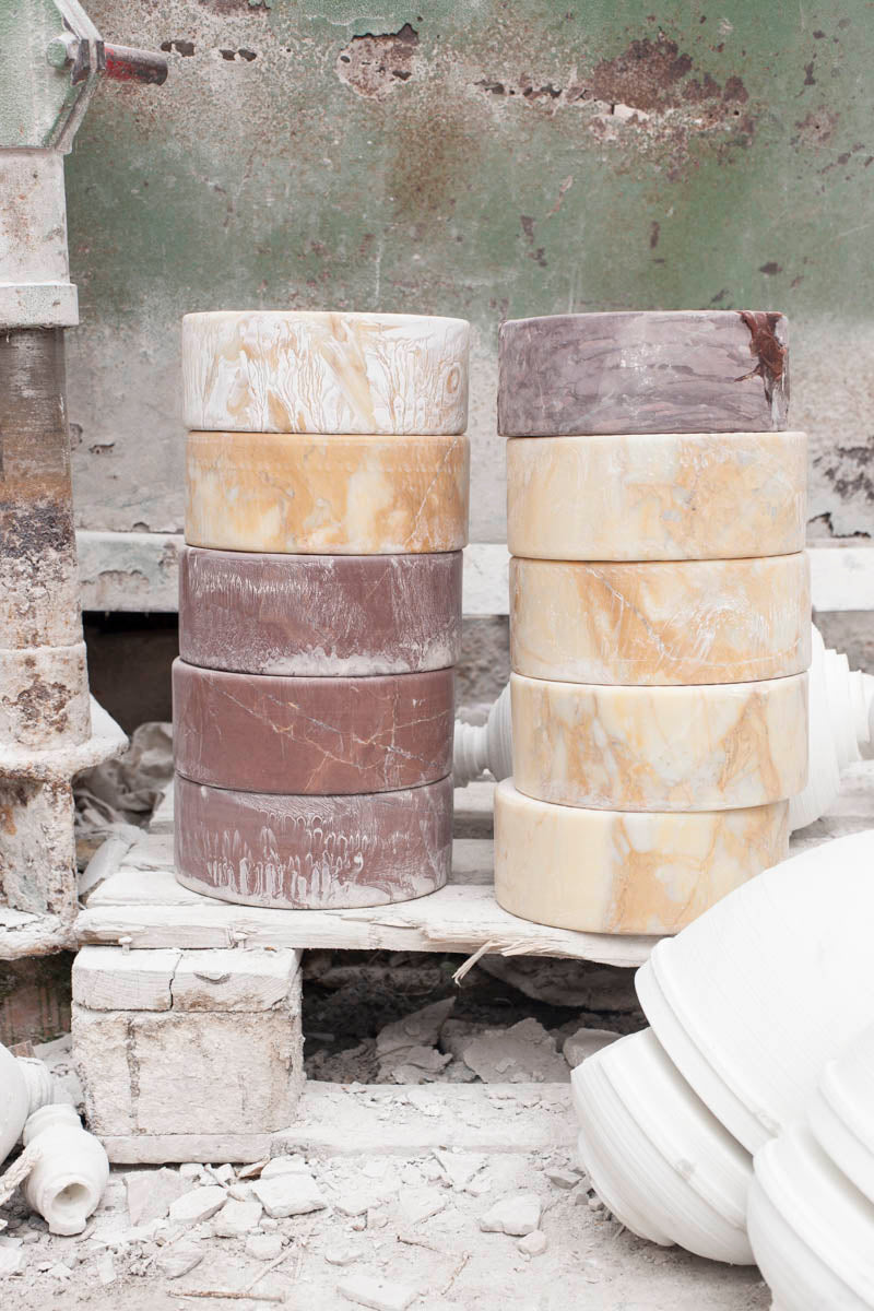 Stacked cylinders of onyx and coloured marble in an Italian stone workshop